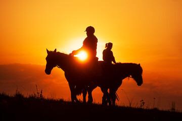the sun is shining through silhouette of a woman riding a horse