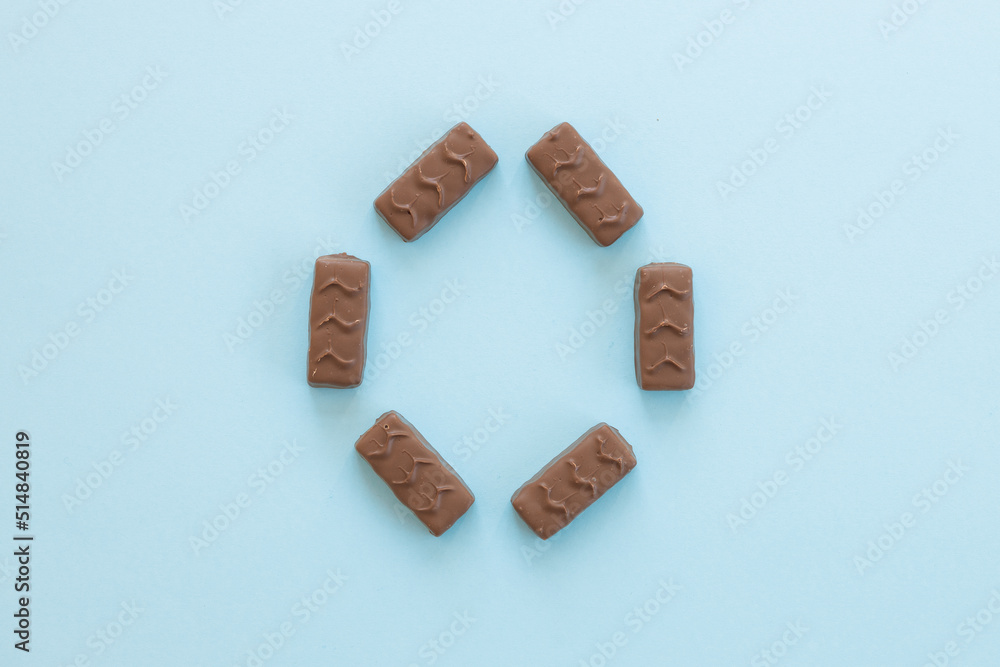 Wall mural chocolate candy bar on blue background