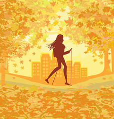 Nordic walking - active woman exercising in the park on an autumn day