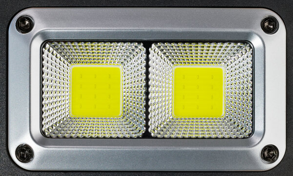 High power photographic electric LED lamp in plastic reflective surface. Close-up of professional reflector from two yellow arrays of electronic semiconductor light emmiting diodes. Electrotechnology. © KPixMining