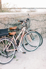 Naklejka na ściany i meble Two vintage style bicycles at the beach at sunrise.