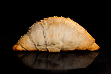 Baked croissant on tray in electric oven, black background - close up view. French cuisine, homemade bakery, breakfast, food, cooking and pastry concept