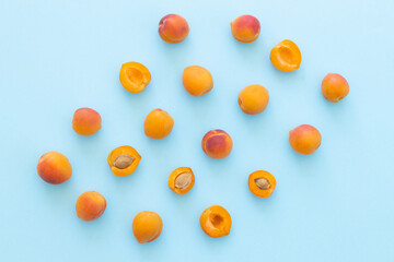 Fototapeta na wymiar Delicious ripe sweet apricots on blue background, flat lay. Space for text