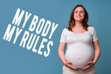 Text my body my rules and happy pregnant woman, studio shot on blue background - obrazy, fototapety, plakaty