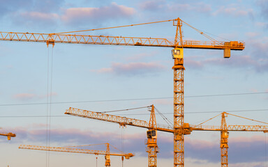 High construction tower crane against the blue sky.