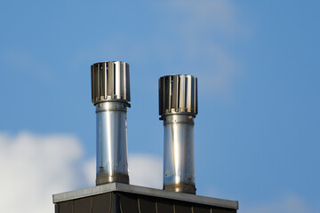Stainless Steel Rotating Chimney Cowls on a chimney clad with slate tiles