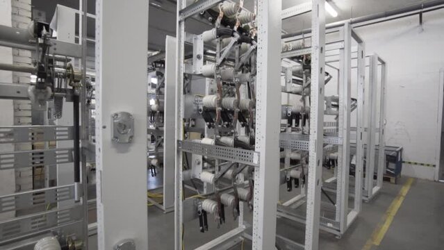 Control power plant board. Action. Industrial electrical equipment with multiple control cells. Modern equipment with ceramic insulators and cables at a power generation substation