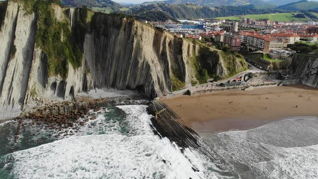 Aerial drone view of famous flysch of Zumaia, Basque Country, Spain. Flysch is a sequence of sedimentary rock layers that progress from deep-water