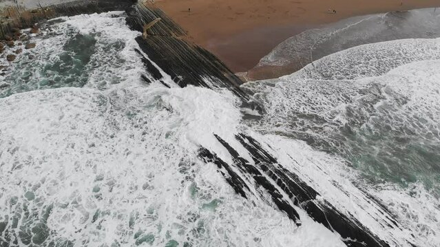 Aerial drone view of famous flysch of Zumaia, Basque Country, Spain. Flysch is a sequence of sedimentary rock layers that progress from deep-water