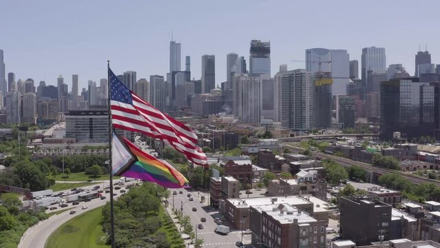 Drone, reversed footage of a Pride Flag over the Chicago Skyline