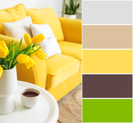 Vase with yellow tulips and cup of coffee on table in living room. Different color patterns