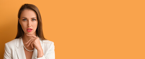 Young woman with beautiful makeup on orange background with space for text