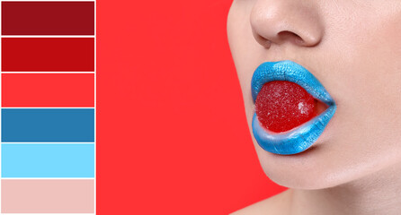 Beautiful young woman with creative makeup and candy in mouth on red background, closeup. Different color patterns