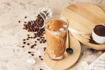 Wooden board with glass of delicious cold brew and coffee beans on grunge table