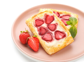 Plate with strawberry puff pastries and mint leaves on white background