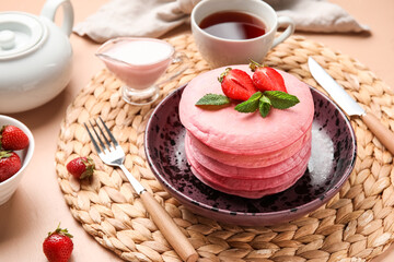 Bowl of tasty pancakes with strawberry on table