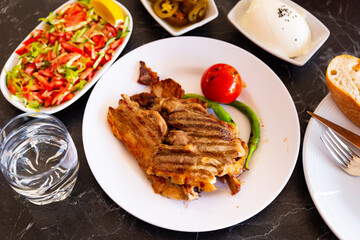 Grilled lamb with tomato and hot pepper. Turkish cuisine