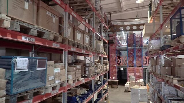 large factory warehouse. Shop aisles. The camera pans inside a large store. Delivery to the warehouse. Logistic business and vehicle with forklift to move boxes and goods. freight mail industry