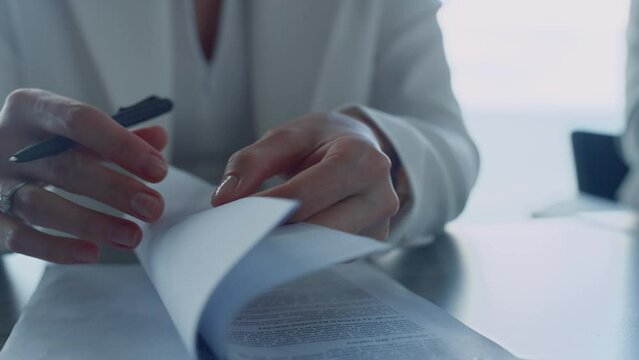 Businesswoman hands checking contract closeup. Lawyer reading legal documents