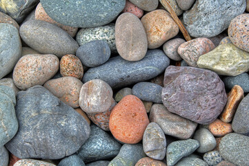 Beach rounded rocks in various colors from ocean