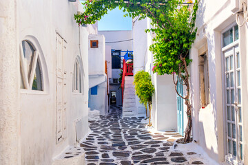 Famous old town narrow street with white houses. Mykonos island, Greece - obrazy, fototapety, plakaty