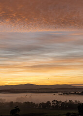 Beautiful sunrise over the Yarra Ranges in Victoria, Australia, with abstract multi-coloured dramatic cloudscape 