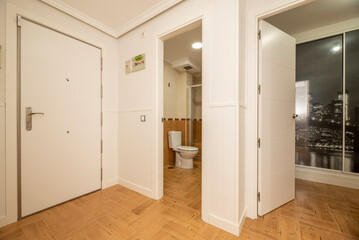 Entrance hall and distributor of a house with ceramic stoneware floors similar to wood and entrance to several rooms