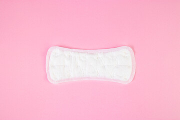 Sanitary pad on pink background. Daily feminine hygiene product. Menstruation concept.