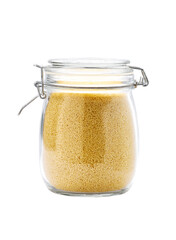 Heap of uncooked dry couscous grains in glass storage jar isolated on white background.