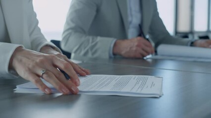 Woman hand holding papers closeup. Managers signing corporate deal with investor