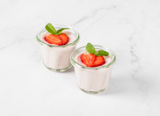 Strawberry cream pudding, Panna Cotta in a glass. Light background