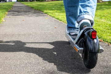 Close-up of electric scooter and riders feet