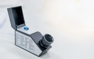 The blue precious stone and put on the refractometer for confirm the type of stone.
