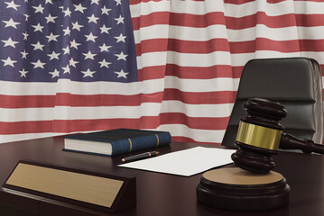 Law and justice concept,  gavel on a wooden desktop and the American flag on background. 3d render.