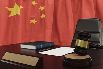 Law and justice concept,  gavel on a wooden desktop and the Peoples Republic of China flag on background. 3d render.