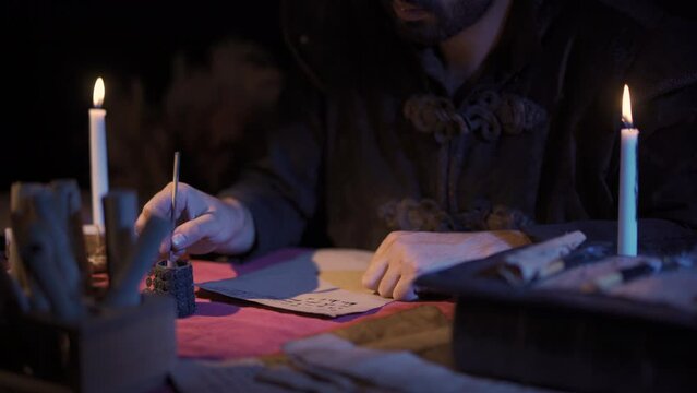 Candlelight letter writing in Ancient Historic setting. Historical scenes.
A person who writes his letter with pen and ink, accompanied by candlelight.
