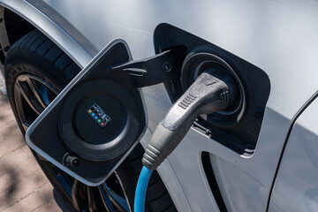 Electric car plugged in and charging