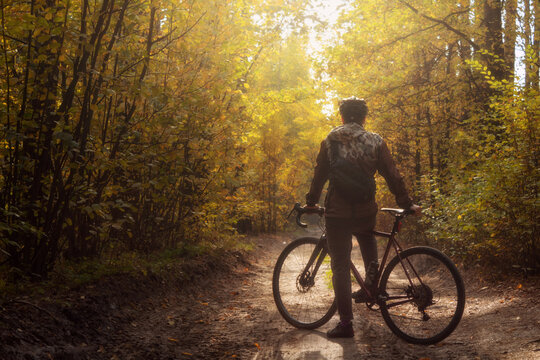 Cyclist rides on a trail in a beautiful autumn forest. Sports and recreation concept.
