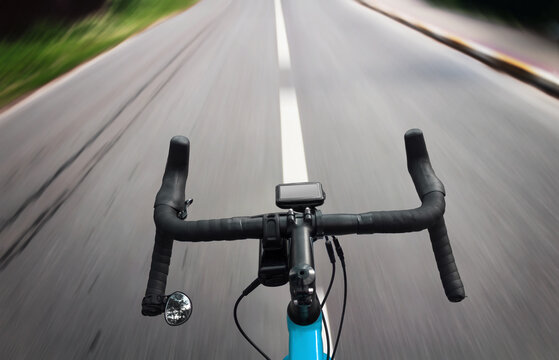 Cyclist rides on the city road with motion blur. POV. First-person view.