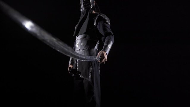 Old time warrior. Black background.
Warrior unsheathing his sword.
