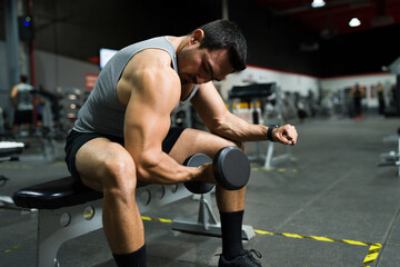 Fototapeta na wymiar Muscular attractive man doing biceps