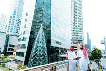 Arab team hold digital tablet uae union teamwork people. Digital marketing arab group of people using smart tablet discuss modern muslim UAE city. Entrepreneur Asian people smile teams meeting.