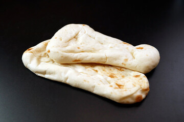 Nan made from wheat to eat with Indian curry on the table