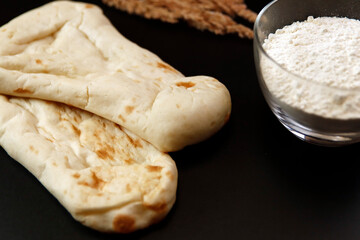 Nan made from wheat to eat with Indian curry on the table