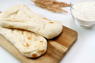 Nan made from wheat to eat with Indian curry on the table