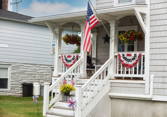 Wooden cute house decorated with flags and flowers. USA. Denb of Independence. Veteran's Day.