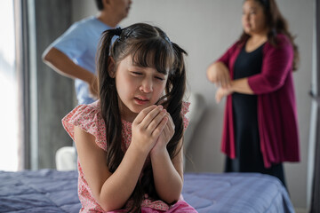 Little Girl Unhappy And Crying Fighting Parents Behind,Wife husband relations concept.