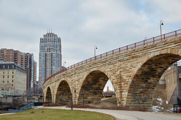 Old and new city skyline with stone arch bridge on the riverfront