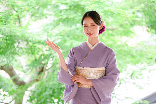Japanese young proprietress welcoming guests in kimono