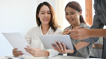 Businesswomen in the meeting, listening their male worker explain and present the project plan.